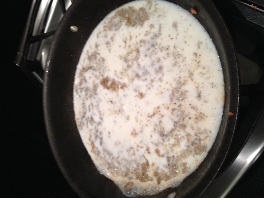Chicken broth with ingredients added to skillet after removing chicken