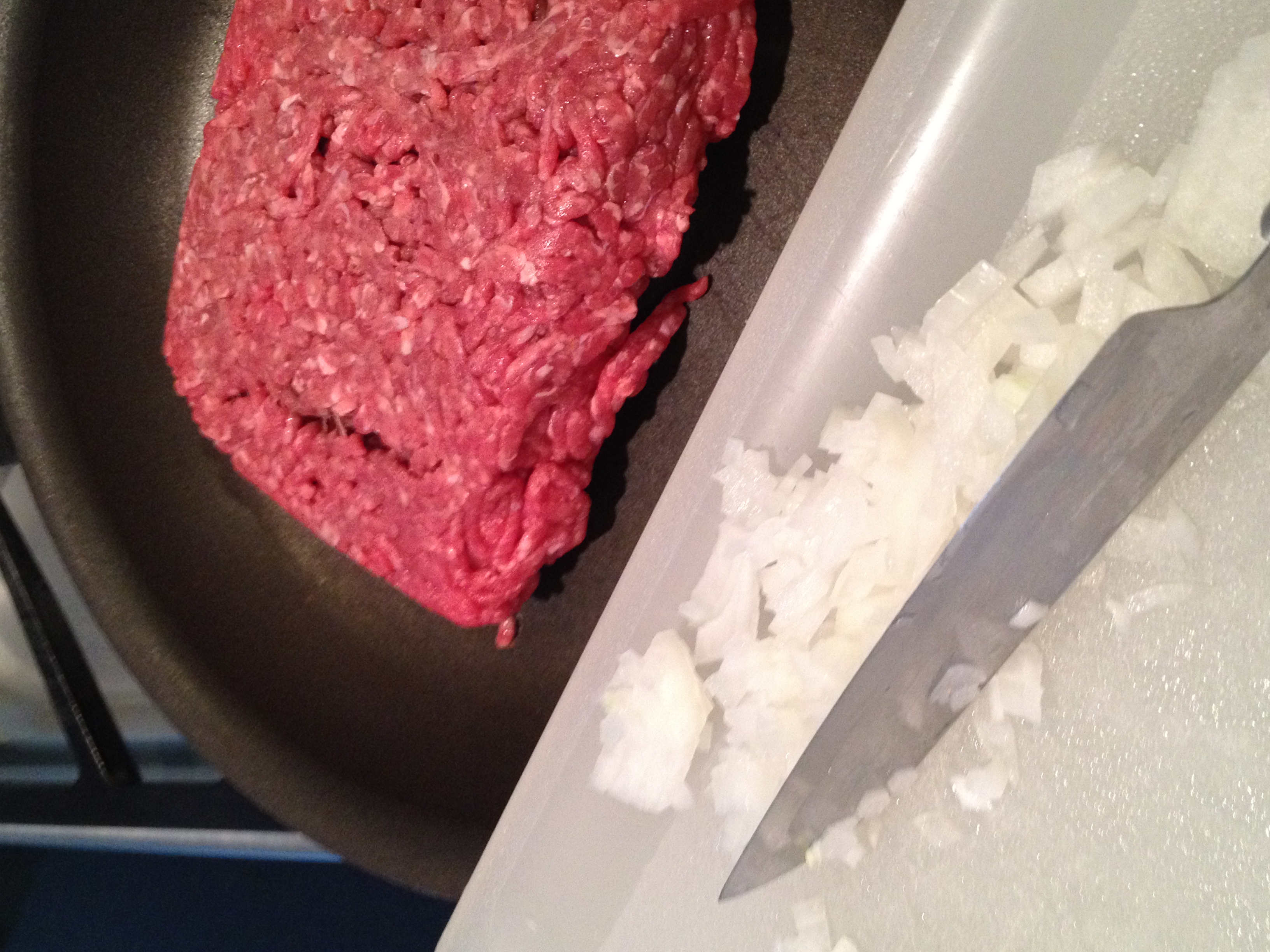 Add chopped onion to ground beef for browning.   Tidbit Tip:  When scraping food from the chopping board use the back edge of the knife to protect the sharp blade edge of the knife.  