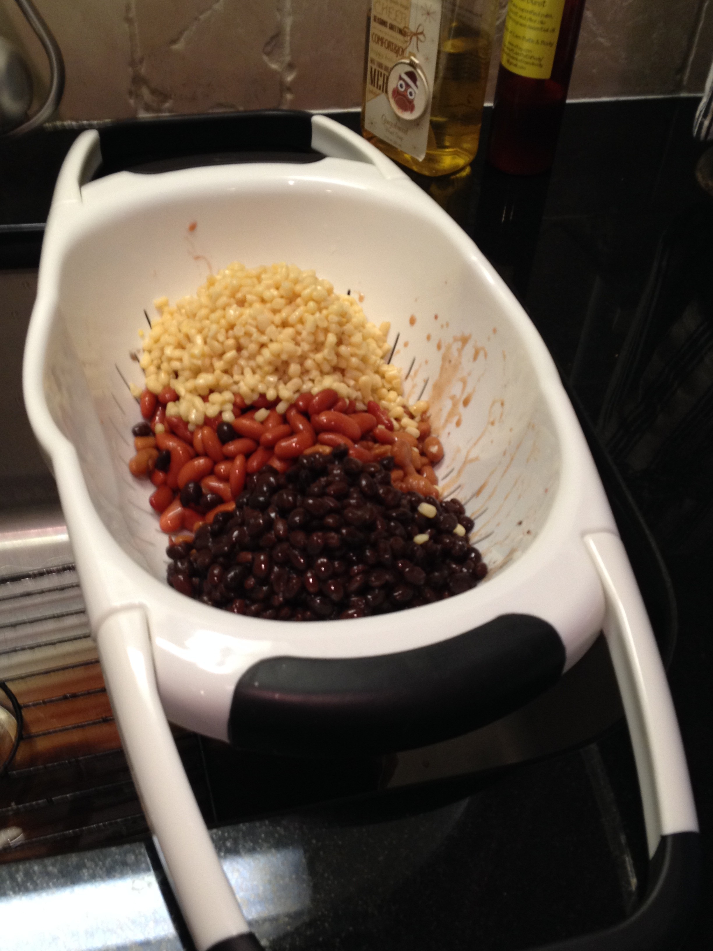 Drain beans and corn in colander.  Tidbit Tip:  This is a great colander because the handles fold out and fit over the sink allowing you to use both hands.