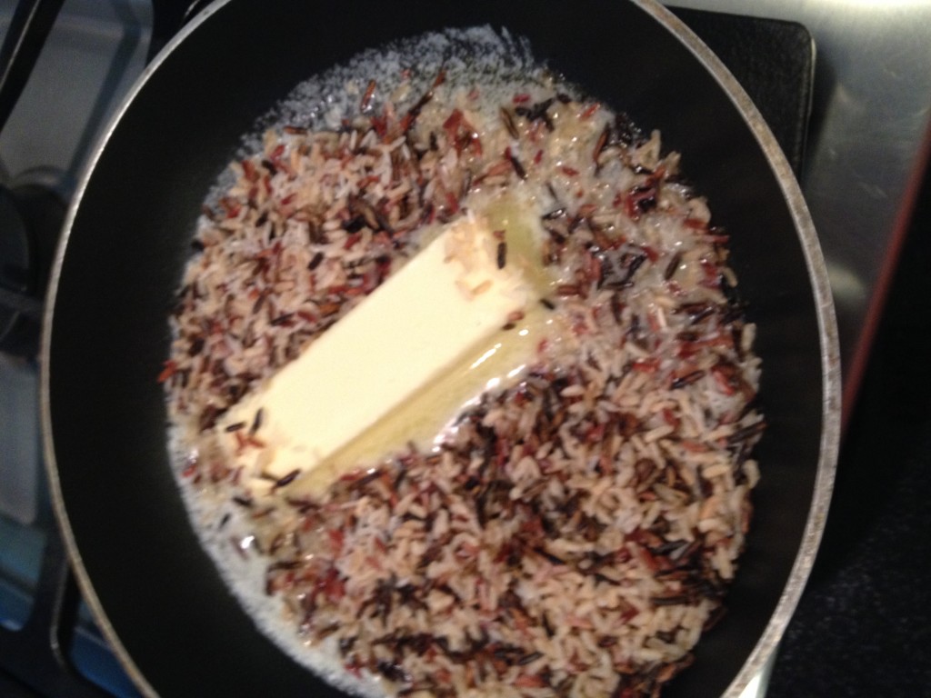 Butter in saute pan with rice added for browning.  Do not add pecans at this point they will get brown.