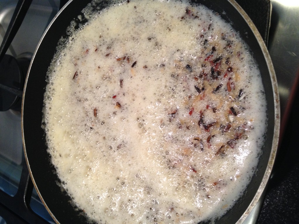 Rice Browning in Hot, Bubbling Butter - Tidbit Tip:  Watch carefully - it browns quickly.  The dark you see is the black rice.